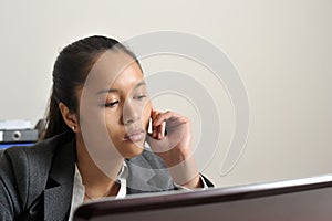 Business woman looking at her laptop screen