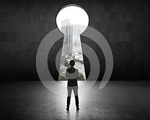 Business Woman Looking Through Key Hole