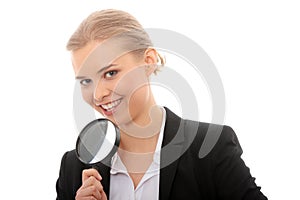 Business woman looking into a magnifying glass