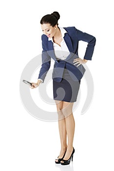 Business woman looking into a magnifying glass