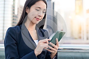 Business woman looking at mobile phone