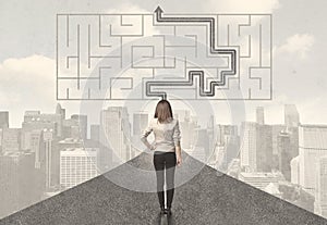 Business woman looking at road with maze and solution