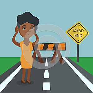 Business woman looking at road sign dead end.