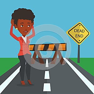 Business woman looking at road sign dead end.