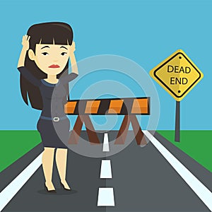 Business woman looking at road sign dead end.