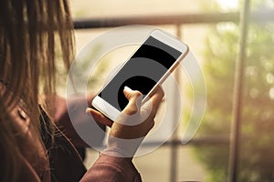 Business woman looking on smart phone in a cafe, Close up of female hands holding cell telephone with screen