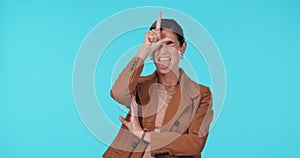 Business woman, loser sign and tongue out in studio for mocking, winning or fun humour. Portrait of female model show