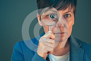Business woman with magnifying glass