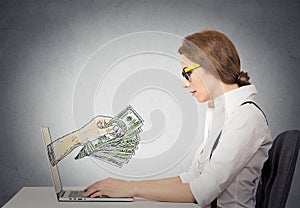 Business woman making money working on line on computer