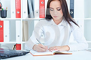 Serious business woman making notes at office workplace. Business job offer, financial success, certified public