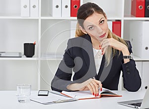 Serious business woman making notes at office workplace. Business job offer, financial success, certified public