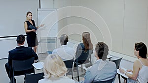 Business woman making presentation on staff meeting at office
