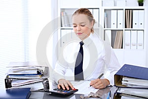 Business woman making report, calculating or checking balance.