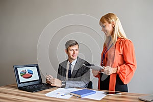 A business woman and man at a office desk  working at the project