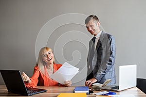 A business woman and man at a office desk  working at the project