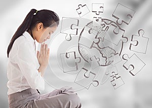 Business woman meditating against blurry grey stairs with jigsaw doodle