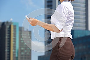 Business woman and mobile phone in the city