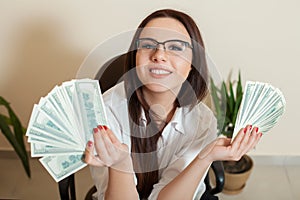 Business woman with money fans in hands