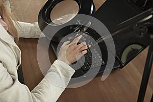Business woman must use a magnifying glass to see the letters on