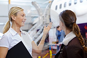 business woman next to airplane