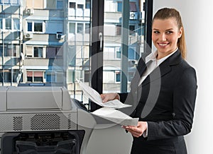 Business woman next to office printer