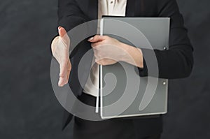 Business woman with notepad on black background