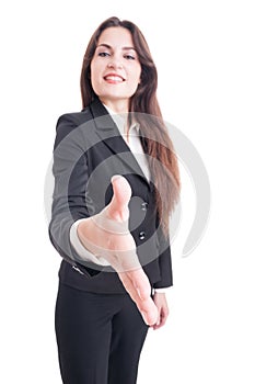 Business woman offering handshake with selective focus on hand