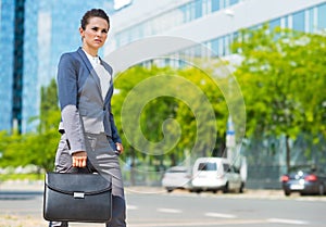 Business woman in office district looking into the distance