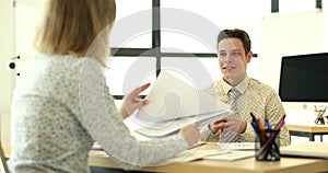A business woman in the office speaks with a man, close-up