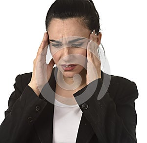 Business woman in office suit suffering migraine pain and strong headache with fingers on her tempo