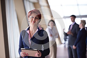 Business woman at office with tablet in front as team leader