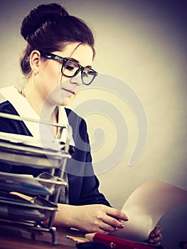 Business woman in office writing something down