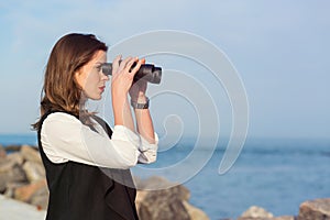 Business woman with a pair of binoculars