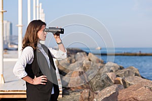 Business woman with a pair of binoculars