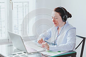 Business woman participating online video conference, webinar photo