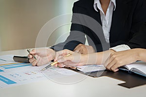 Business woman and partner hand pointing at finance chart for planning about marketing, tax, accounting, statistics and analytic