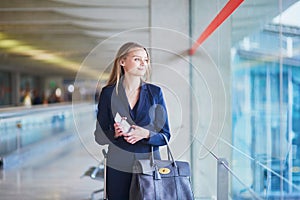 Business woman with passport and boarding pass in international airport