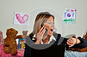 Business woman on phone looks at watch and is late