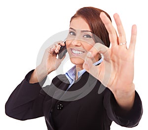 Business woman with phone and ok gesture