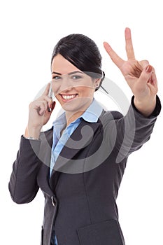 Business woman with phone and victory gesture