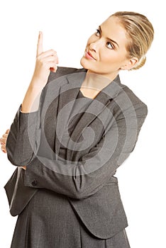 Business woman pointing at copyspace