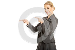Business woman pointing at copyspace on the left