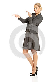 Business woman pointing at copyspace on the left