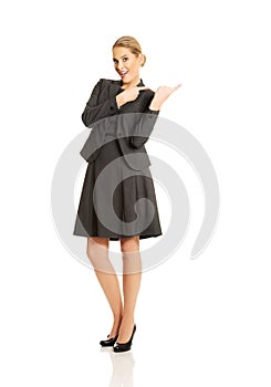 Business woman pointing at copyspace on the right