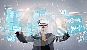 Business woman pointing at financial data while wearing VR glasses. Contraption.