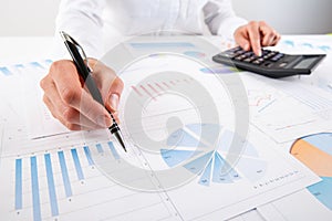 Business woman pointing at graph document close-up