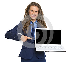 Business woman pointing on laptop blank screen