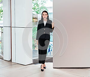 Business woman pointing to blank board the billboard