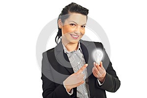 Business woman pointing to light bulb