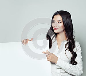 Business woman pointing up her finger and showing signboard photo